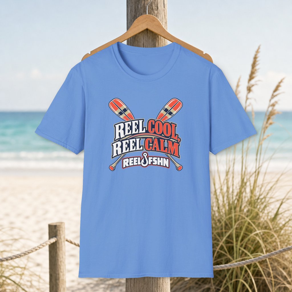 REEL COOL REEL CALM T-Shirt on a hanger beside a sandy beach and turquoise coastal water