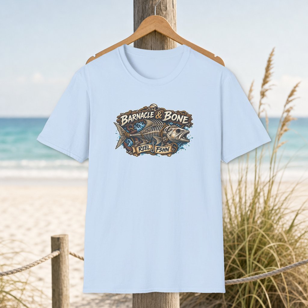 Barnacle & Bone T-Shirt on a hanger beside a sandy beach and turquoise coastal water
