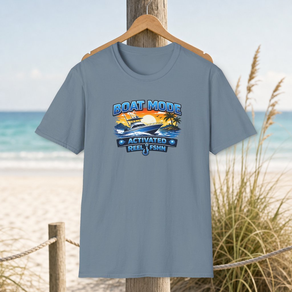 Boat Mode Activated T-Shirt on a hanger beside a sandy beach and turquoise coastal water