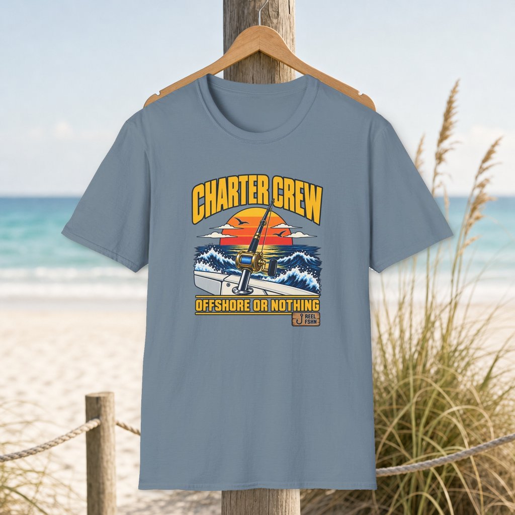 Charter Crew Offshore or Nothing T-Shirt on a hanger beside a sandy beach and turquoise coastal water