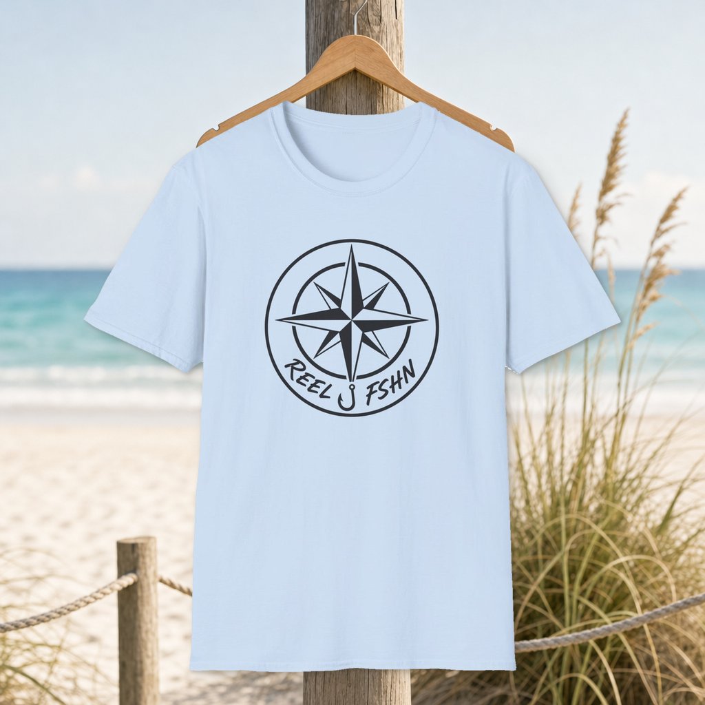 Compass & Logo T-Shirt on a hanger beside a sandy beach and turquoise coastal water