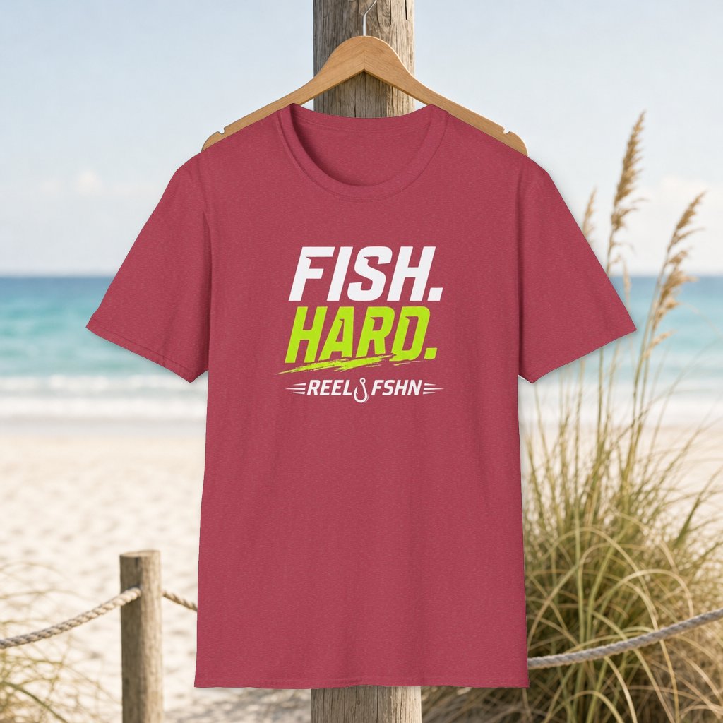 Fish Hard T-Shirt on a hanger beside a sandy beach and turquoise coastal water