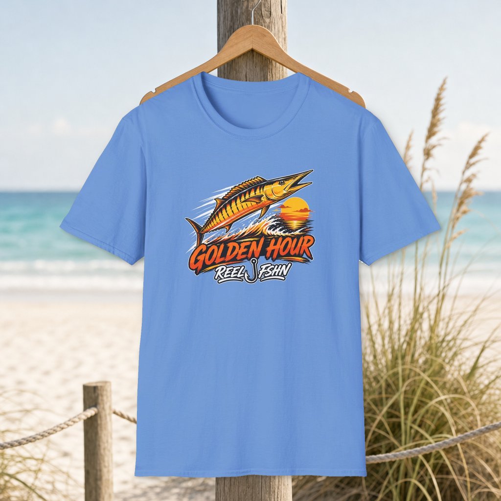 Golden Hour Wahoo T-Shirt on a hanger beside a sandy beach and turquoise coastal water