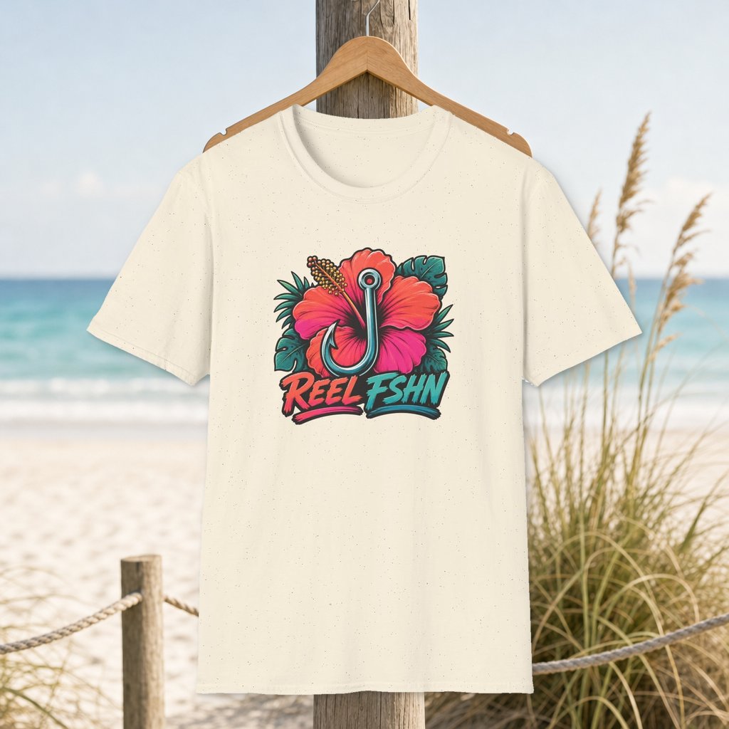 Hibiscus Hook Badge T-Shirt on a hanger beside a sandy beach and turquoise coastal water