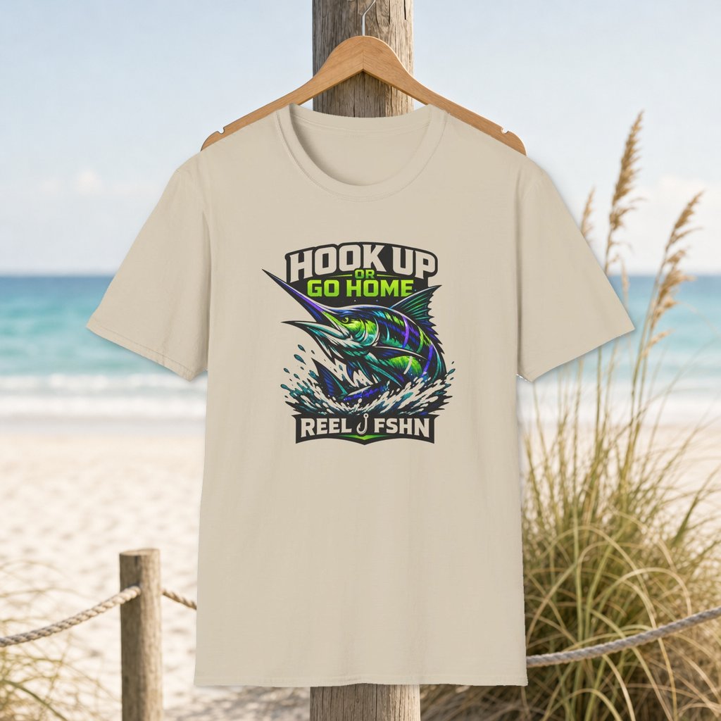 Hook Up Or Go Home Marlin T-Shirt on a hanger beside a sandy beach and turquoise coastal water