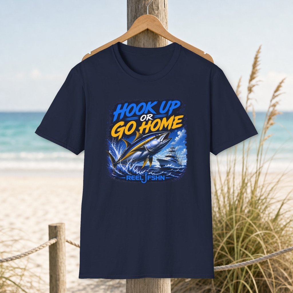 Hook Up Or Go Home Tuna T-Shirt on a hanger beside a sandy beach and turquoise coastal water