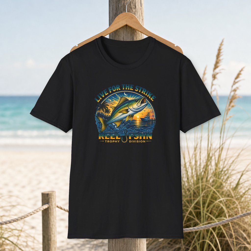 Live For The Strike T-Shirt on a hanger beside a sandy beach and turquoise coastal water