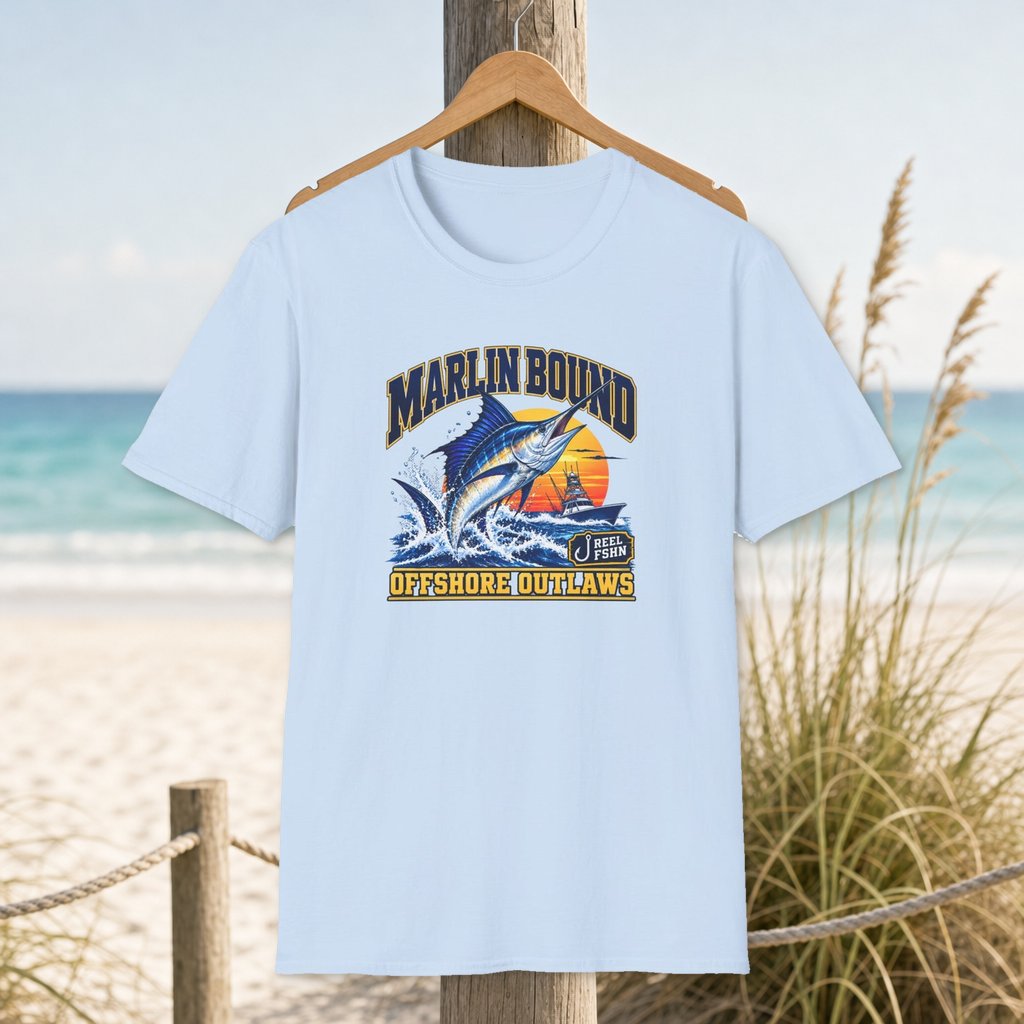 Marlin Bound T-Shirt on a hanger beside a sandy beach and turquoise coastal water