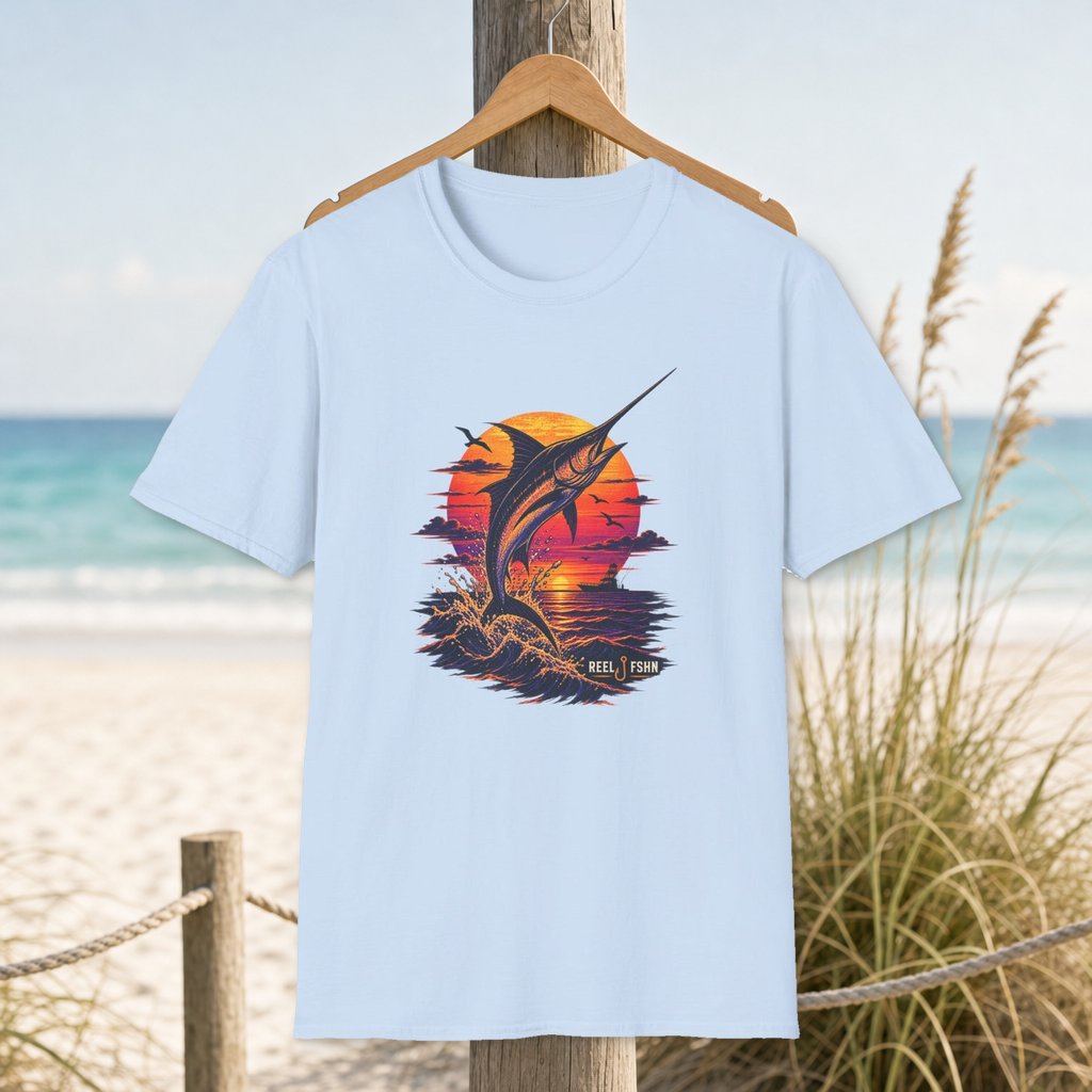 Marlin Sunset Silhouette  T-Shirt on a hanger beside a sandy beach and turquoise coastal water