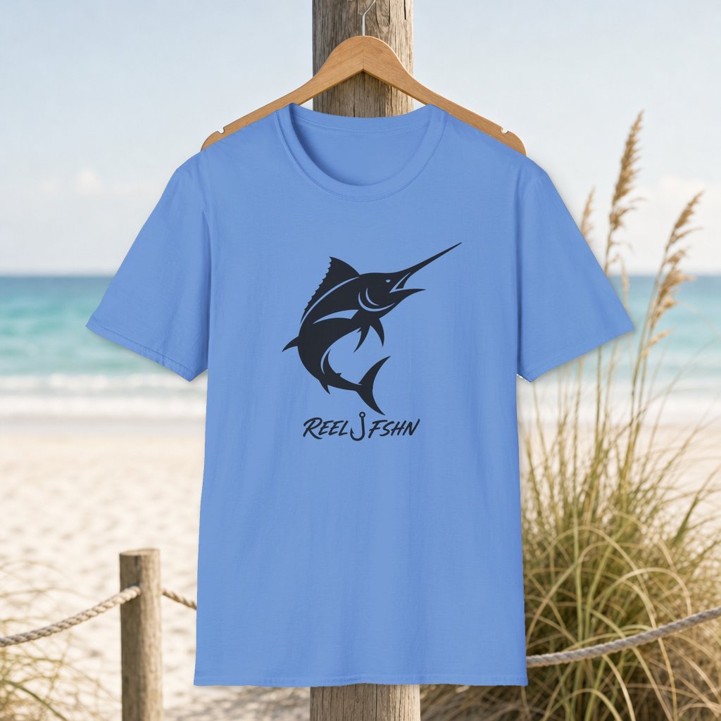 Marlin with REEL FSHN Logo T-Shirt on a hanger beside a sandy beach and turquoise coastal water