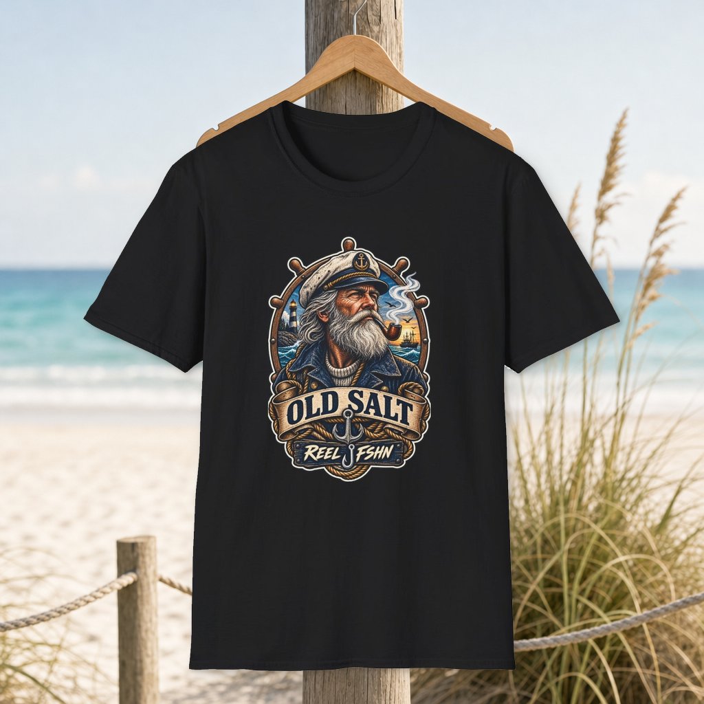 Old Salt T-Shirt on a hanger beside a sandy beach and turquoise coastal water