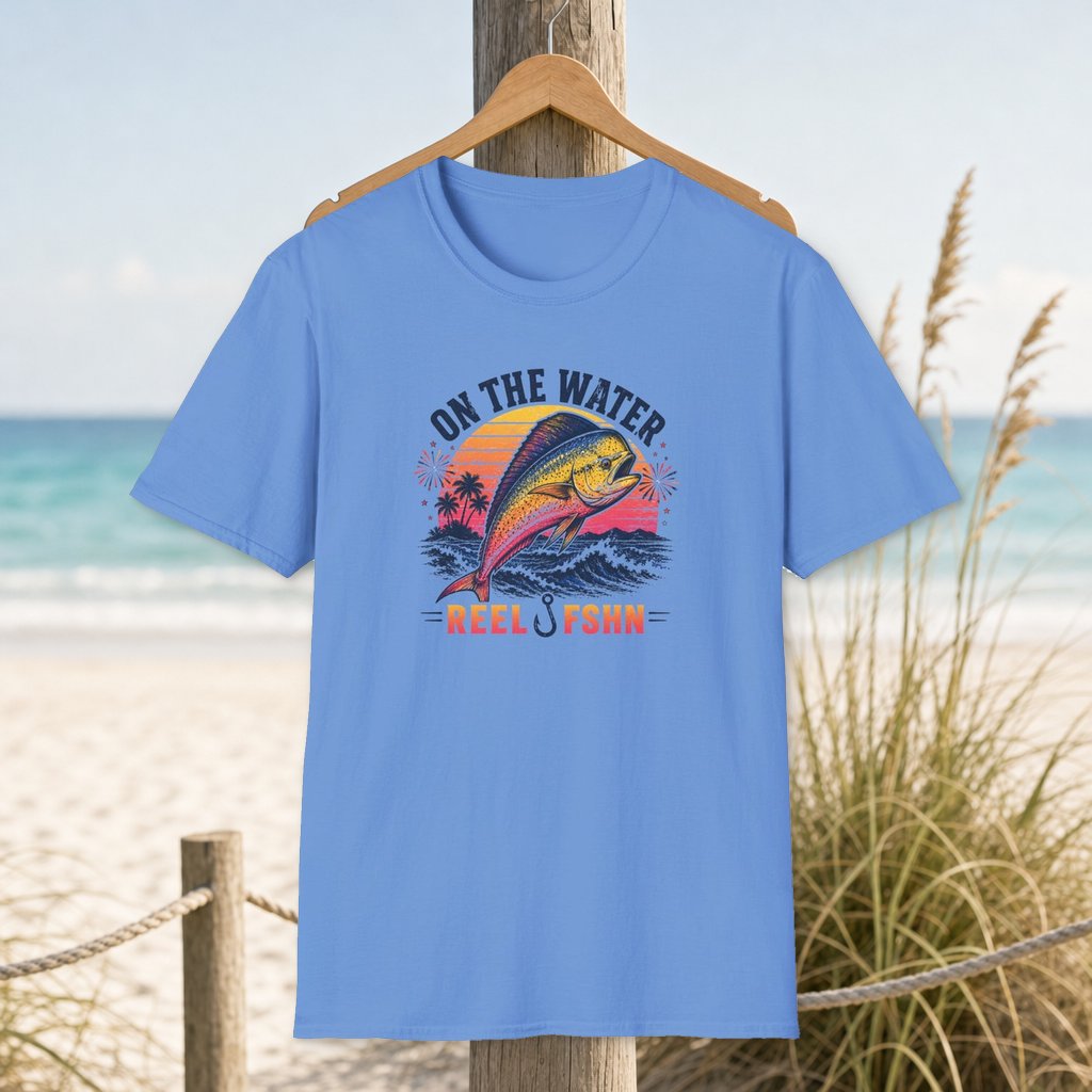 On The Water T-Shirt on a hanger beside a sandy beach and turquoise coastal water