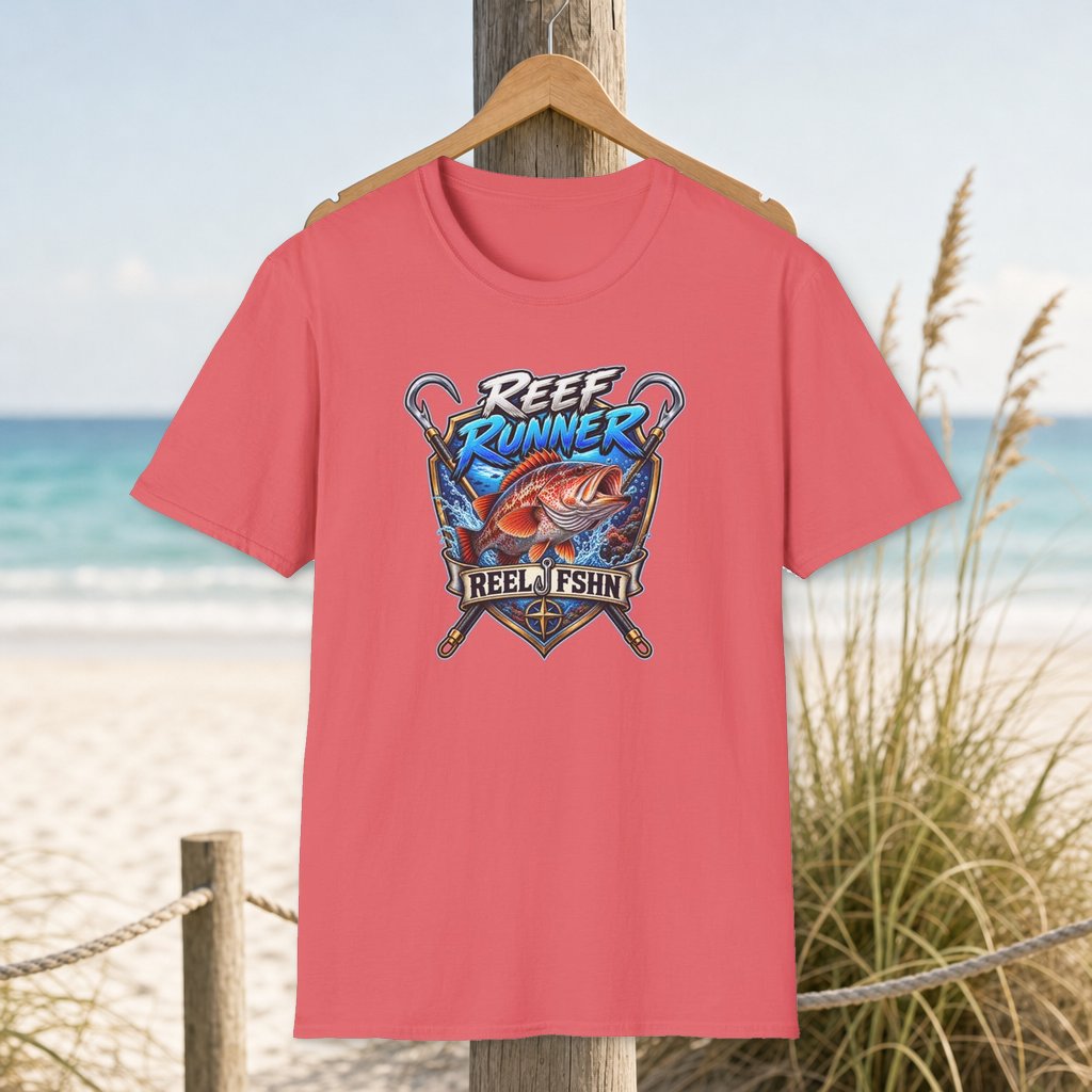 REEF Runner T-Shirt on a hanger beside a sandy beach and turquoise coastal water