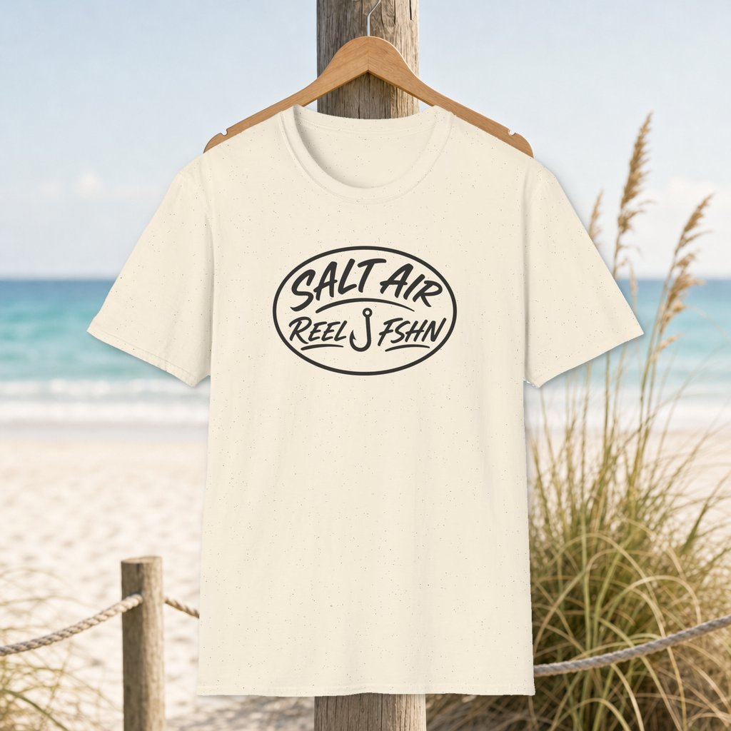 Salt Air with Logo T-Shirt on a hanger beside a sandy beach and turquoise coastal water