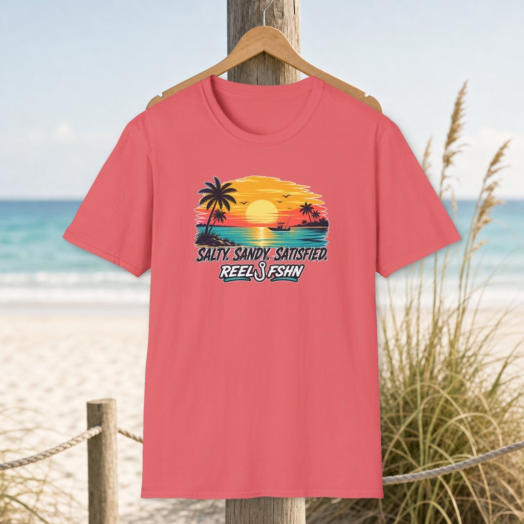 Salty. Sandy. Satisfied. T-Shirt on a hanger beside a sandy beach and turquoise coastal water