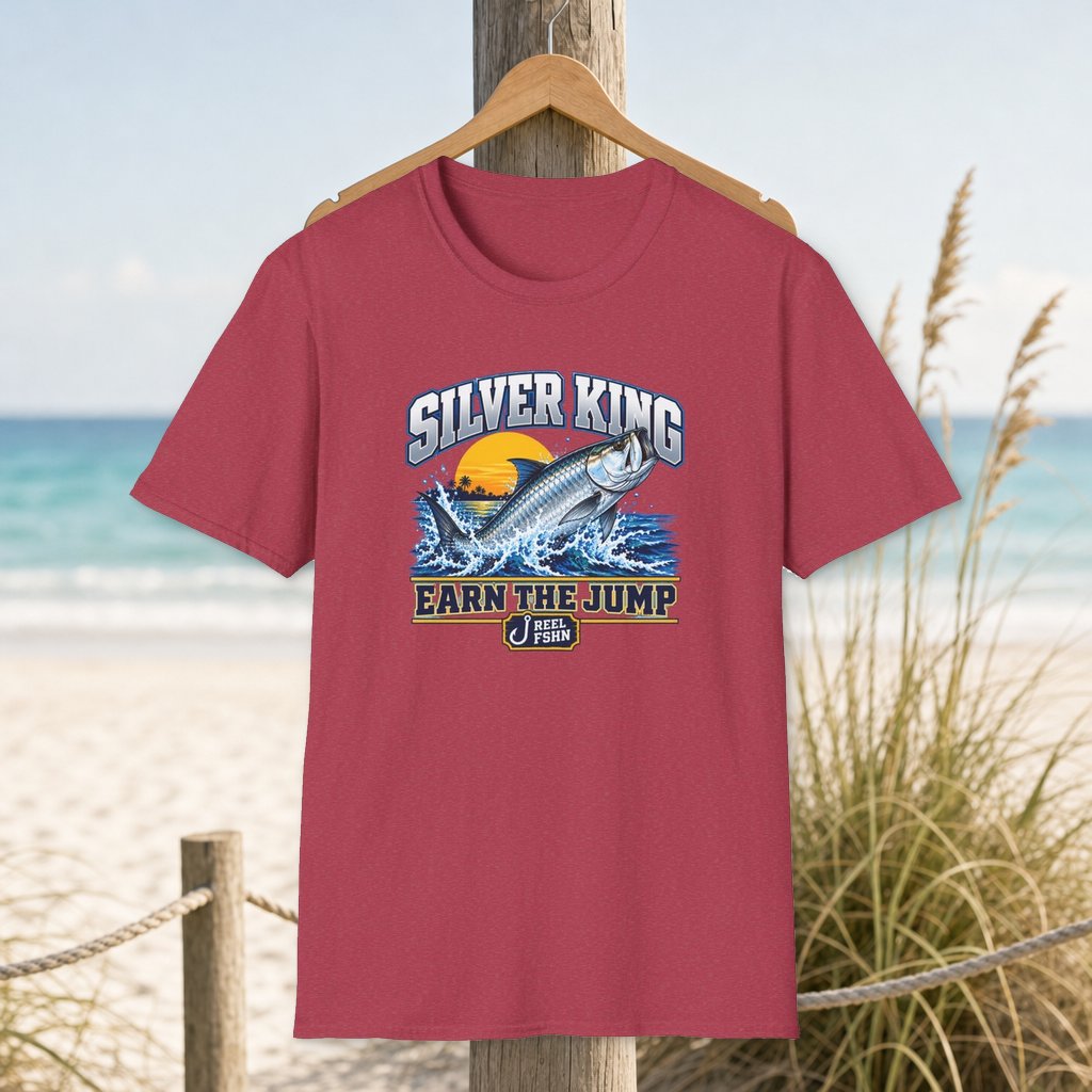 Silver King T-Shirt on a hanger beside a sandy beach and turquoise coastal water
