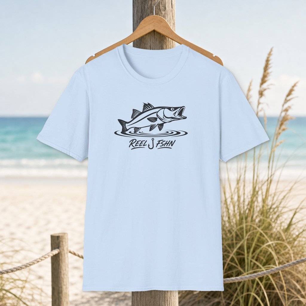 Snook Strike with Logo T-Shirt on a hanger beside a sandy beach and turquoise coastal water