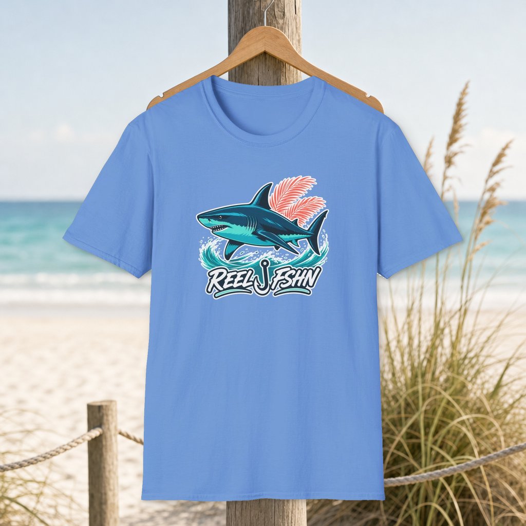 Tropical Shark T-Shirt on a hanger beside a sandy beach and turquoise coastal water