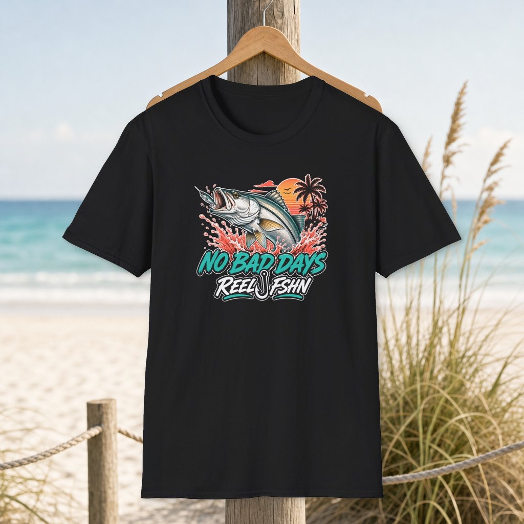 Tropical Snook T-Shirt on a hanger beside a sandy beach and turquoise coastal water