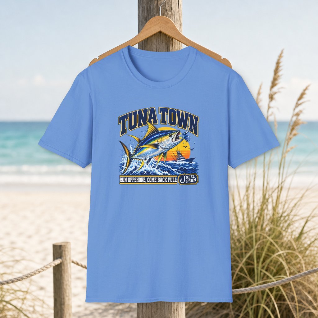Tuna Town T-Shirt on a hanger beside a sandy beach and turquoise coastal water