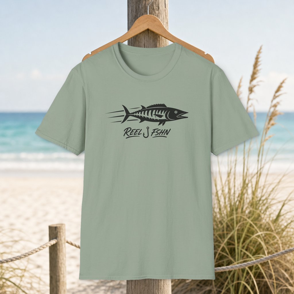 Wahoo Speed Sticker T-Shirt on a hanger beside a sandy beach and turquoise coastal water