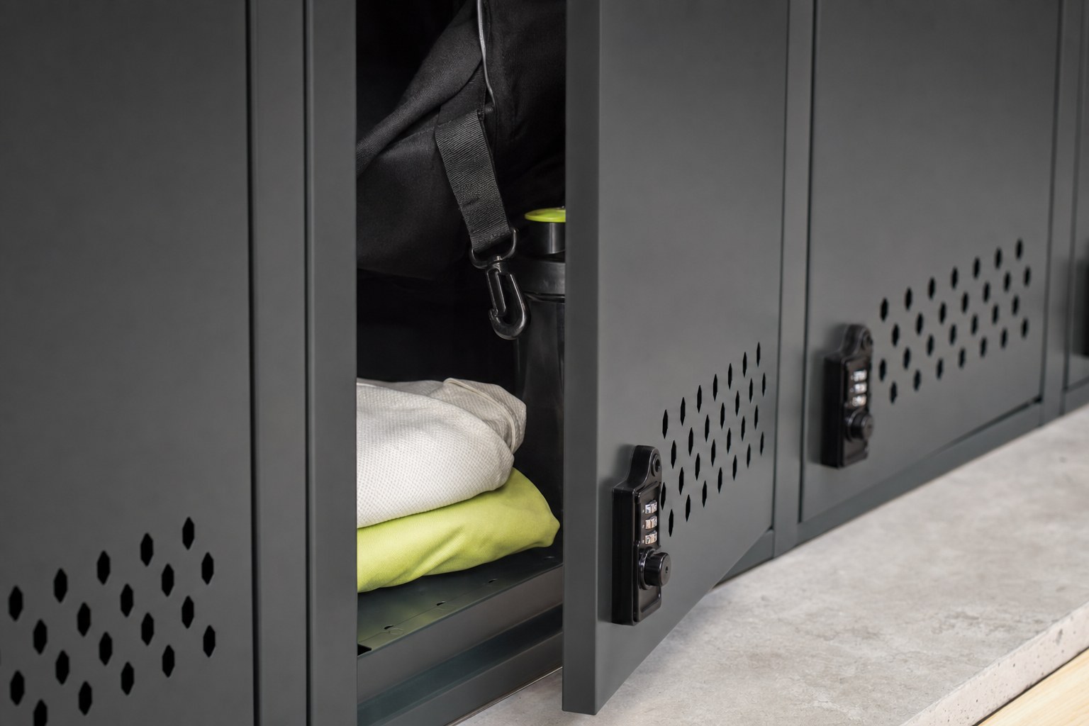 A gym locker holding a bag, folded clothes, and water bottle