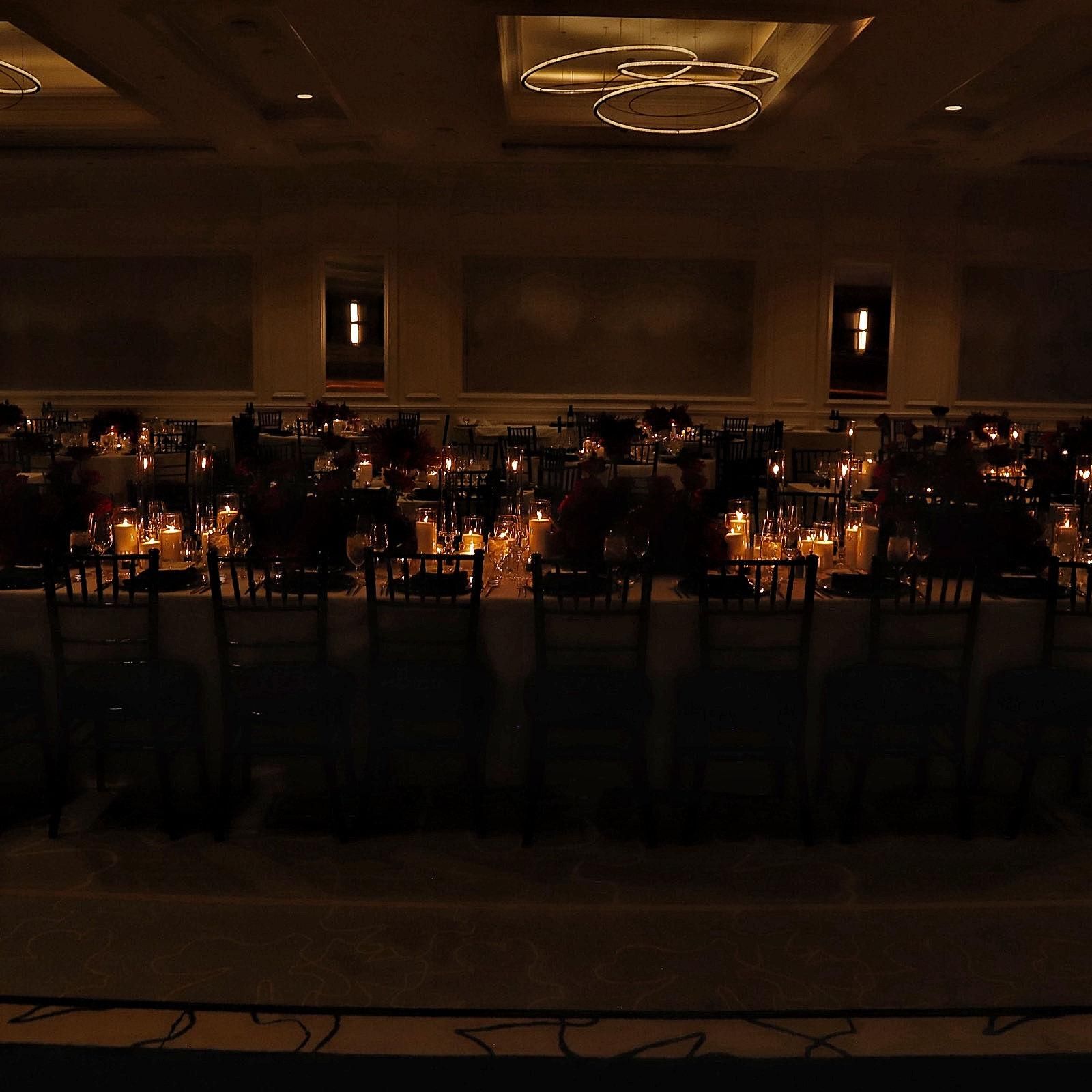 Layered candlelight across reception tables in the Four Seasons ballroom