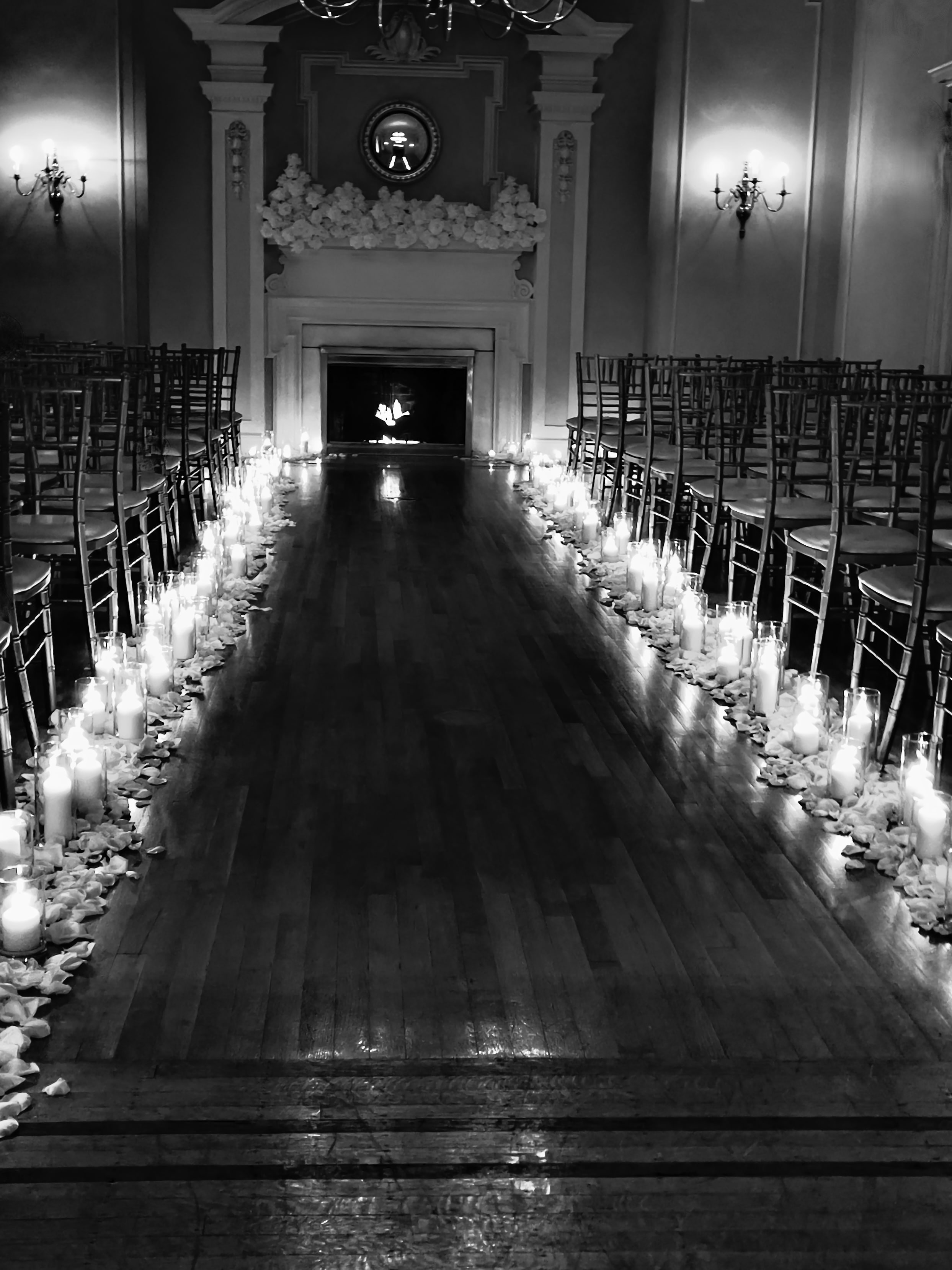 Candlelit ceremony aisle lined with glass vessels