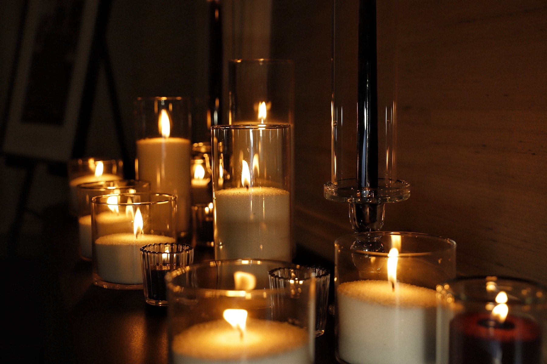 Layered candlelight at the Four Seasons with pearled wax cylinders, dark tapers, and smaller glass accents