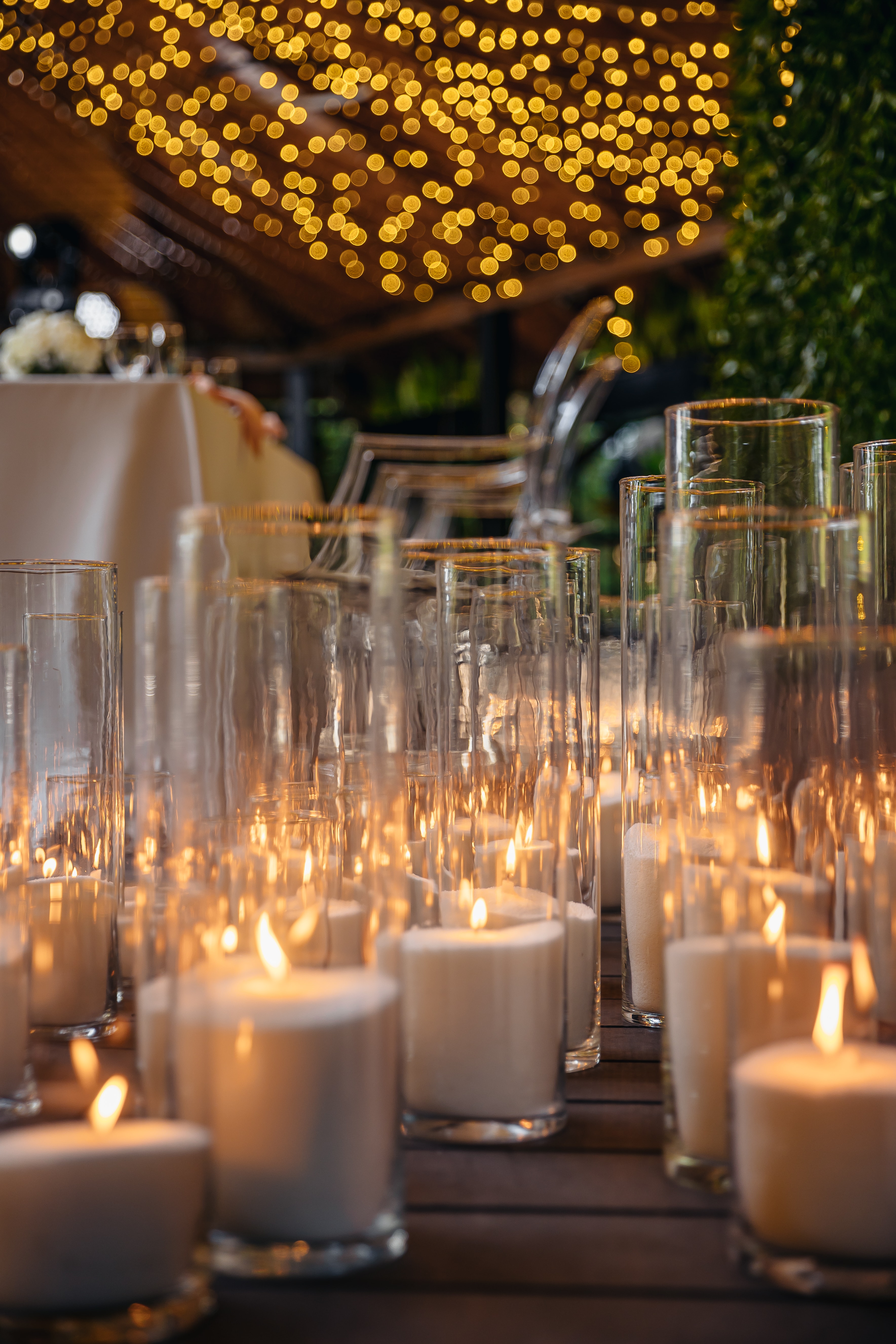 A layered floor installation of glass cylinder candlelight