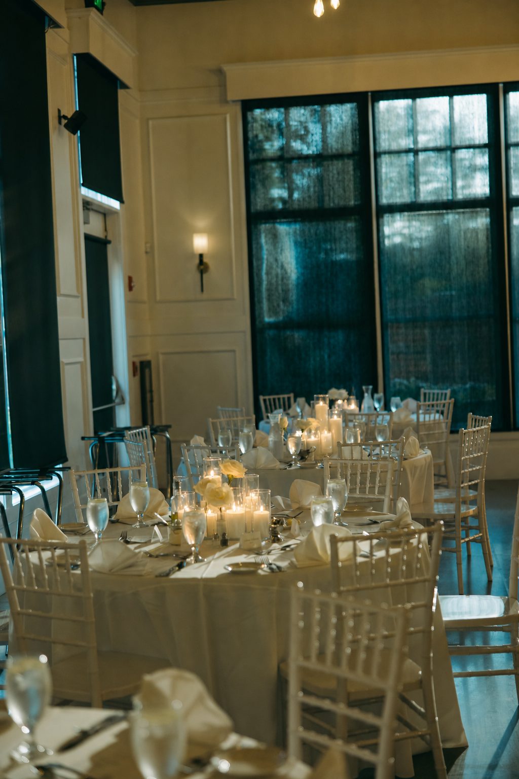 Round reception tables styled with glass cylinder candlelight at The Crawford in Naperville