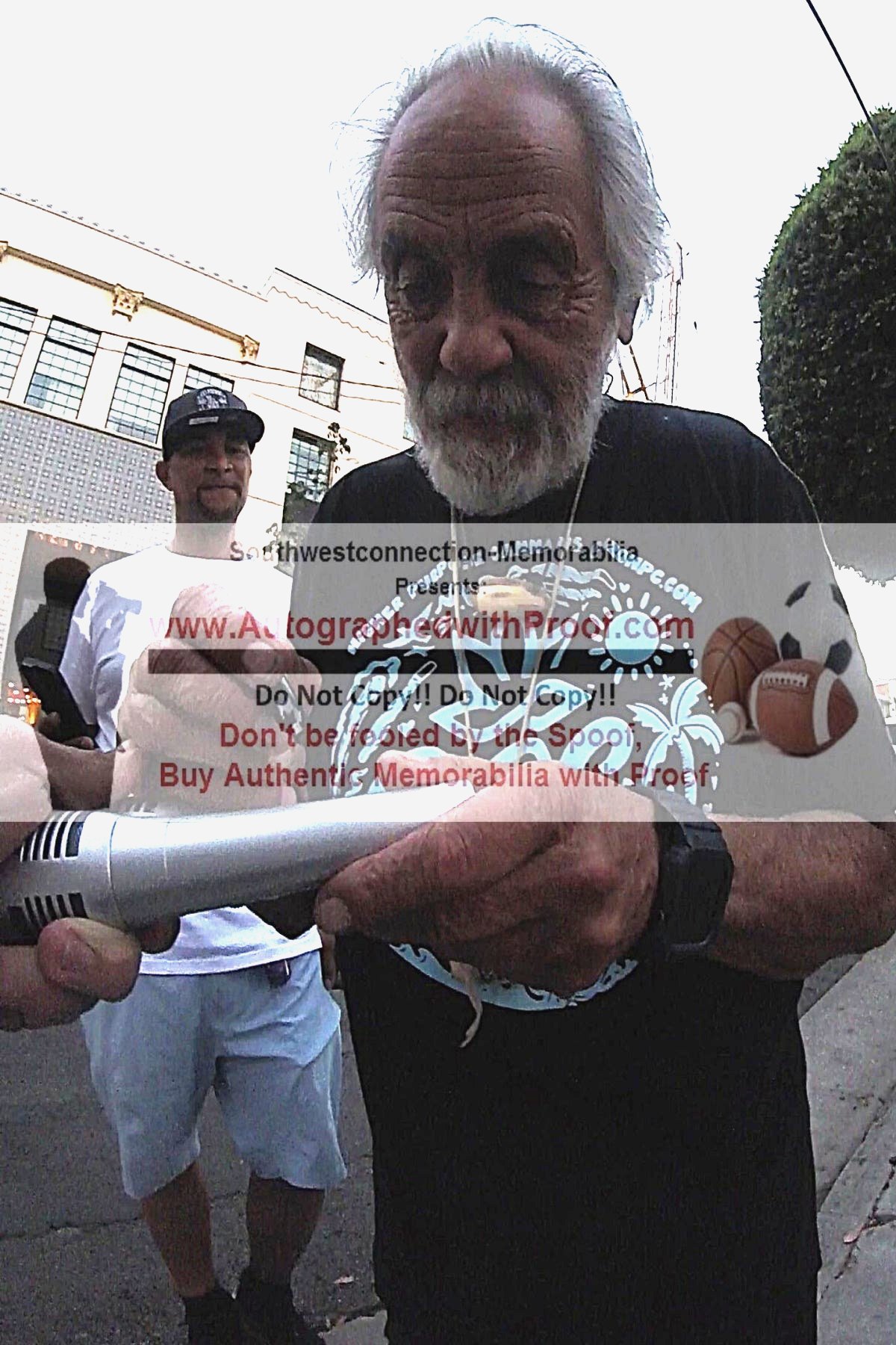 Tommy Chong signing an autographed microphone