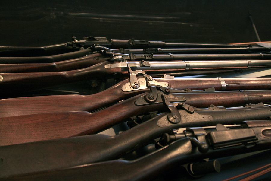 Vintage firearms arranged safely on a workbench