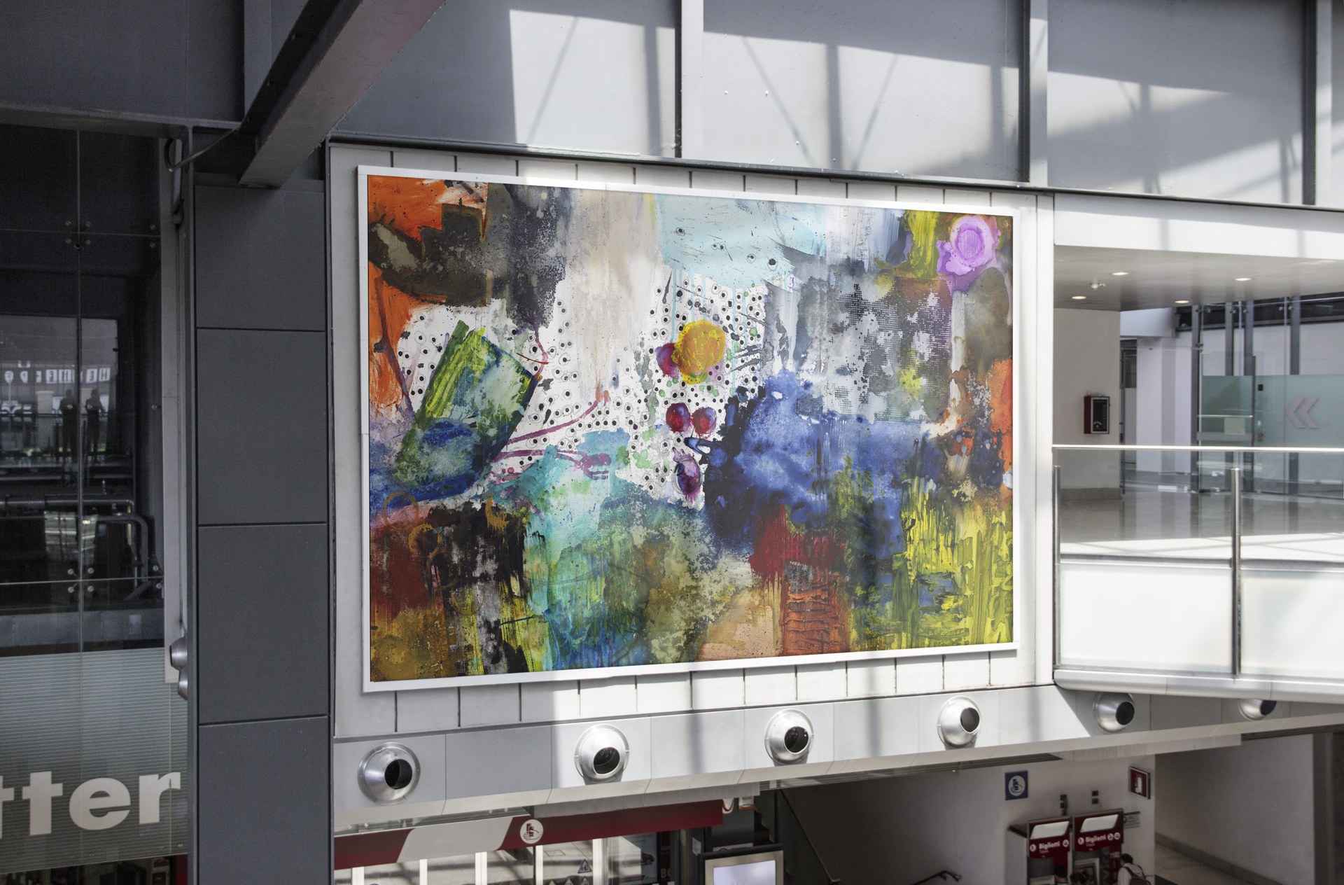 Michel Keck artwork displayed on a large public wall in an airport setting