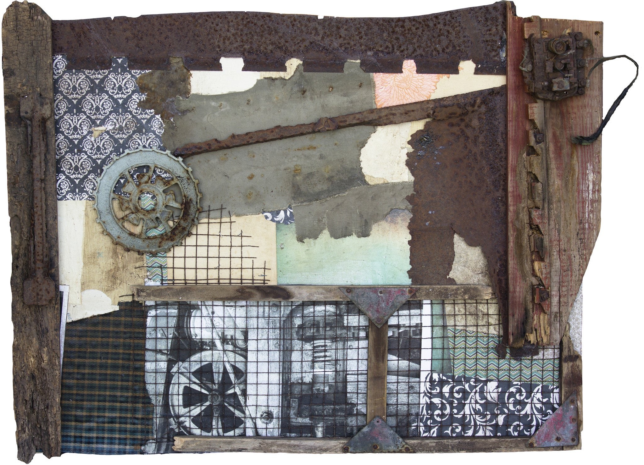 Mixed-media wall assemblage by Michel Keck featuring layered reclaimed wood, rusted metal, patterned papers, and a circular gear element. The composition includes grid-like wire mesh and torn textures in muted earth tones and faded blues.