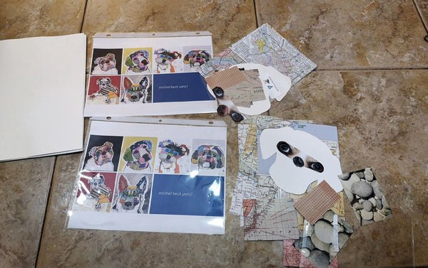 Two sets of printed sheets featuring colorful dog portraits by Michel Keck, laid out on a tiled floor alongside cut-out paper shapes with dog eyes and various map and stone pattern papers.