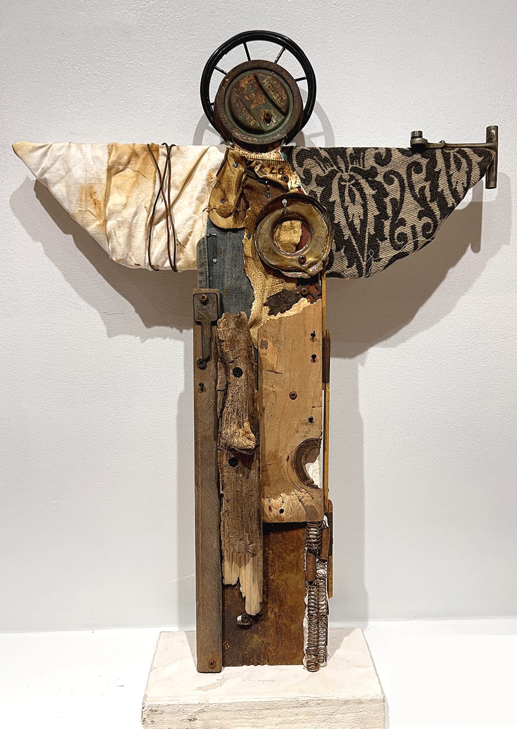 Angel assemblage made from weathered wood, found metal and patterned material