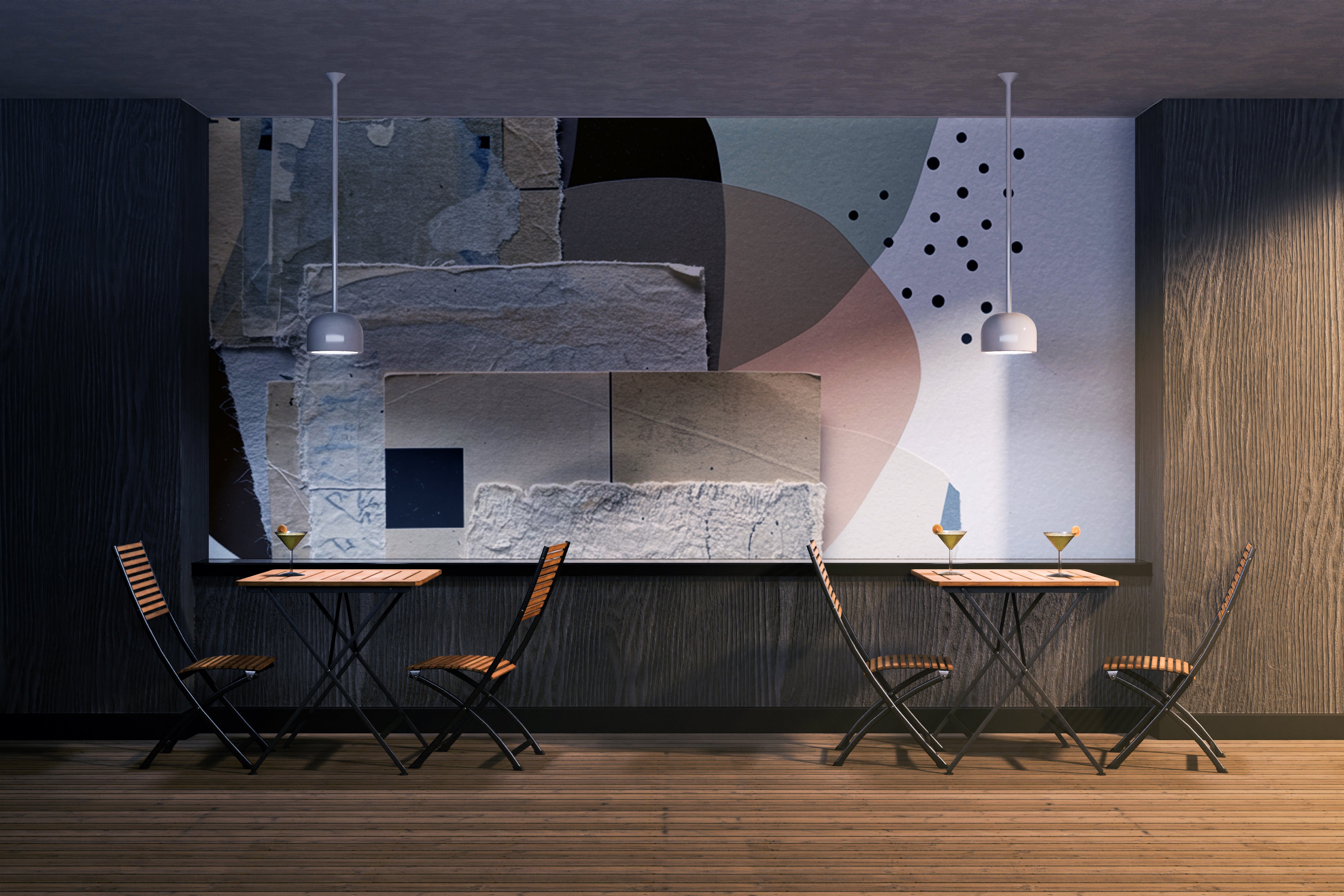 Interior view of a modern dining area with two small wooden tables and four matching chairs against a dark wood-paneled wall. A large abstract wall mural by Michel Keck features layered geometric shapes, textured stone-like patterns, and muted tones of gray, beige, black, and soft pink.