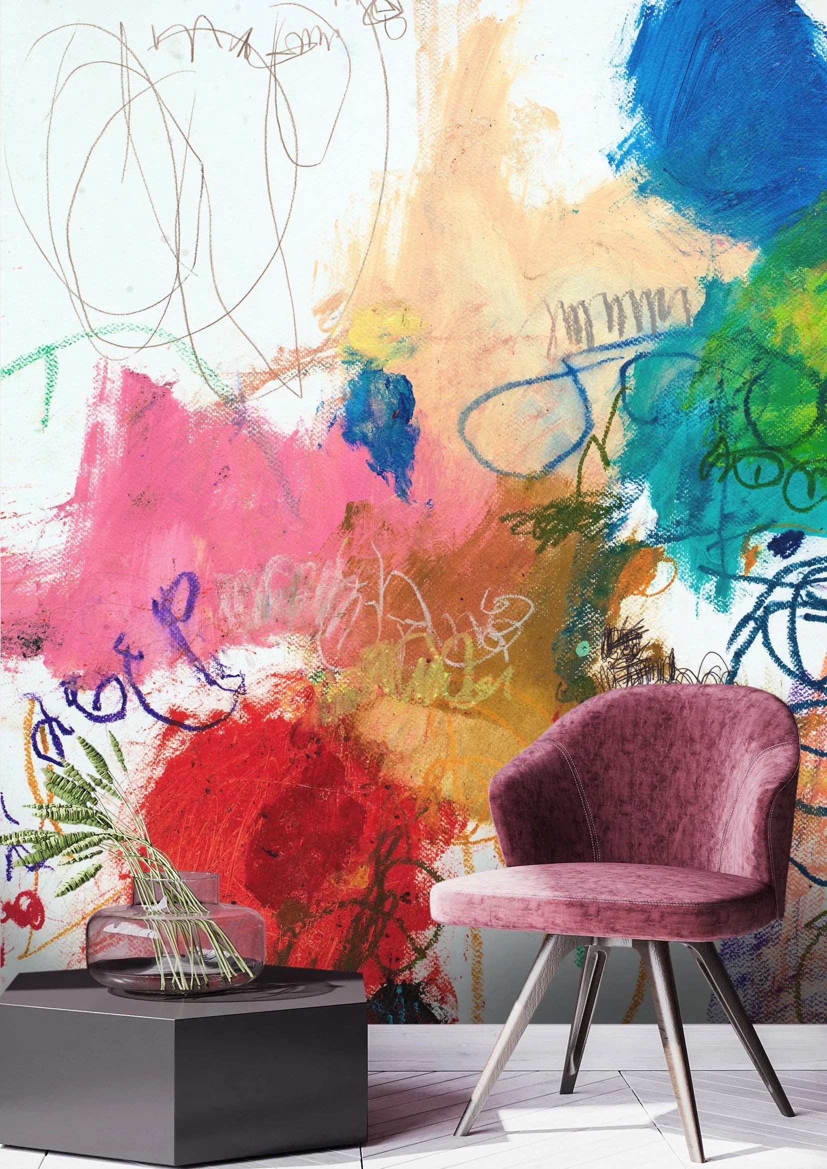 Abstract wall mural by Michel Keck featuring vibrant splashes of red, pink, blue, green, and orange with scribbled lines and textured brushstrokes, set behind a modern mauve velvet chair and a black geometric side table with a glass vase.