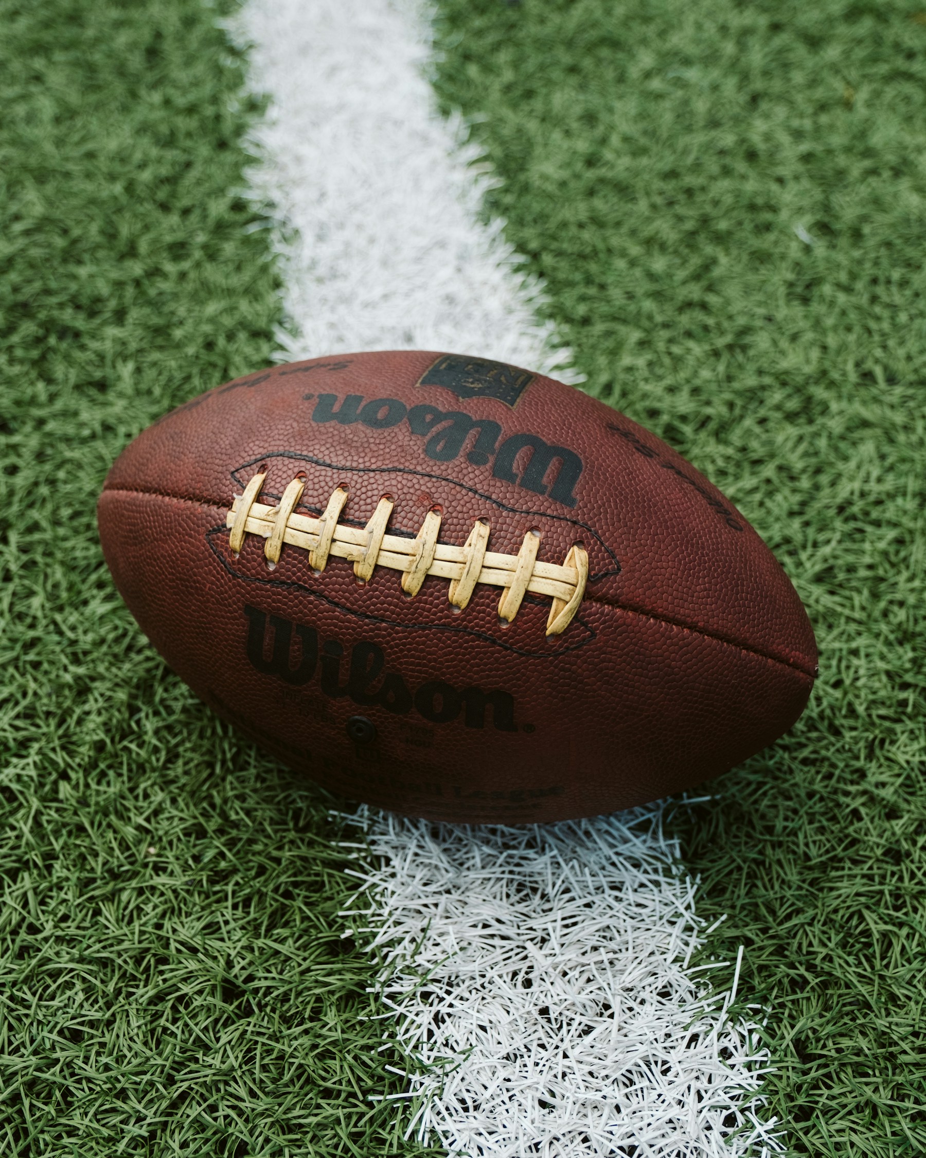 Football waiting on a marked field before a game