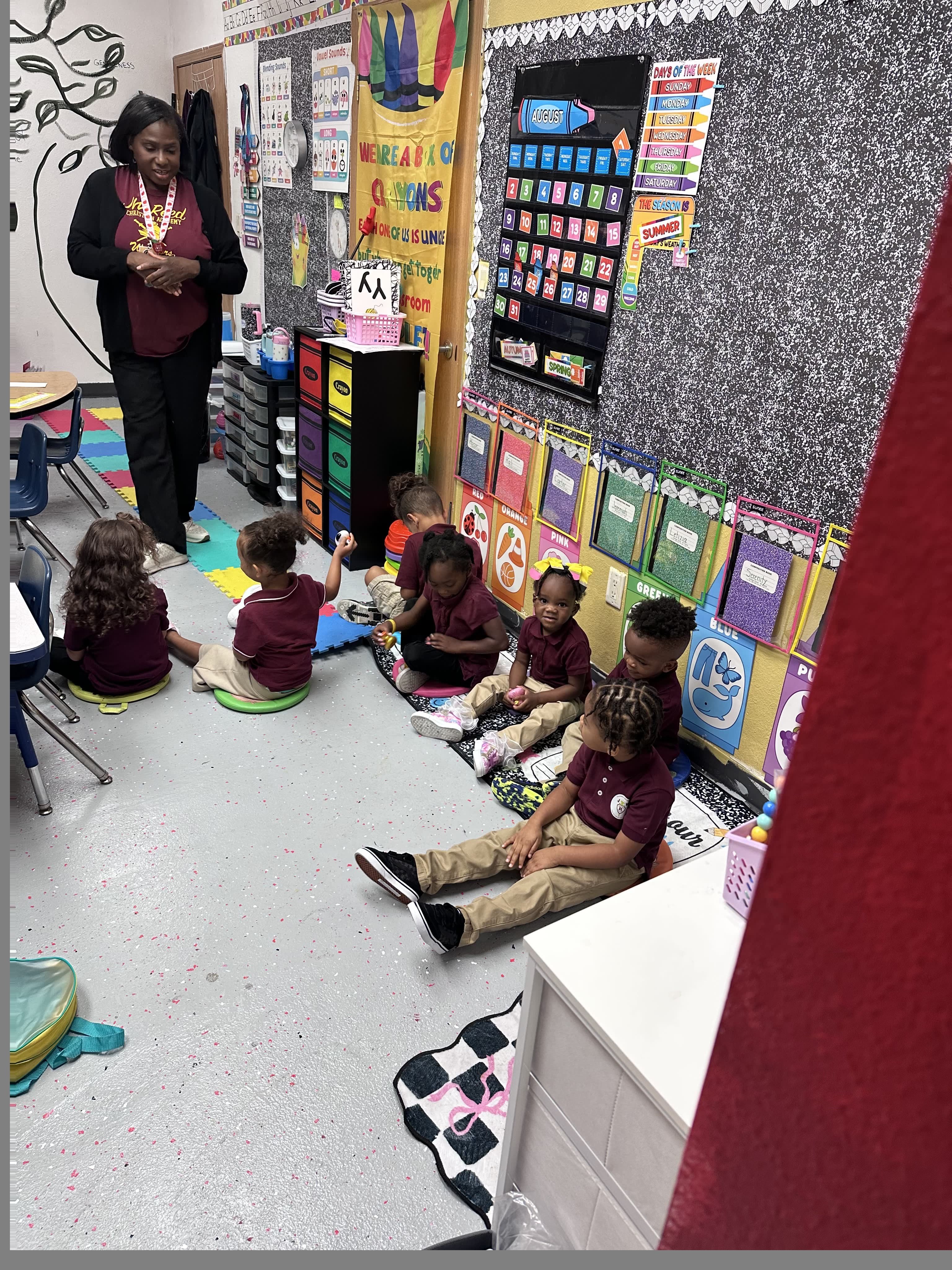 Preschool students gathered with their teacher in the classroom