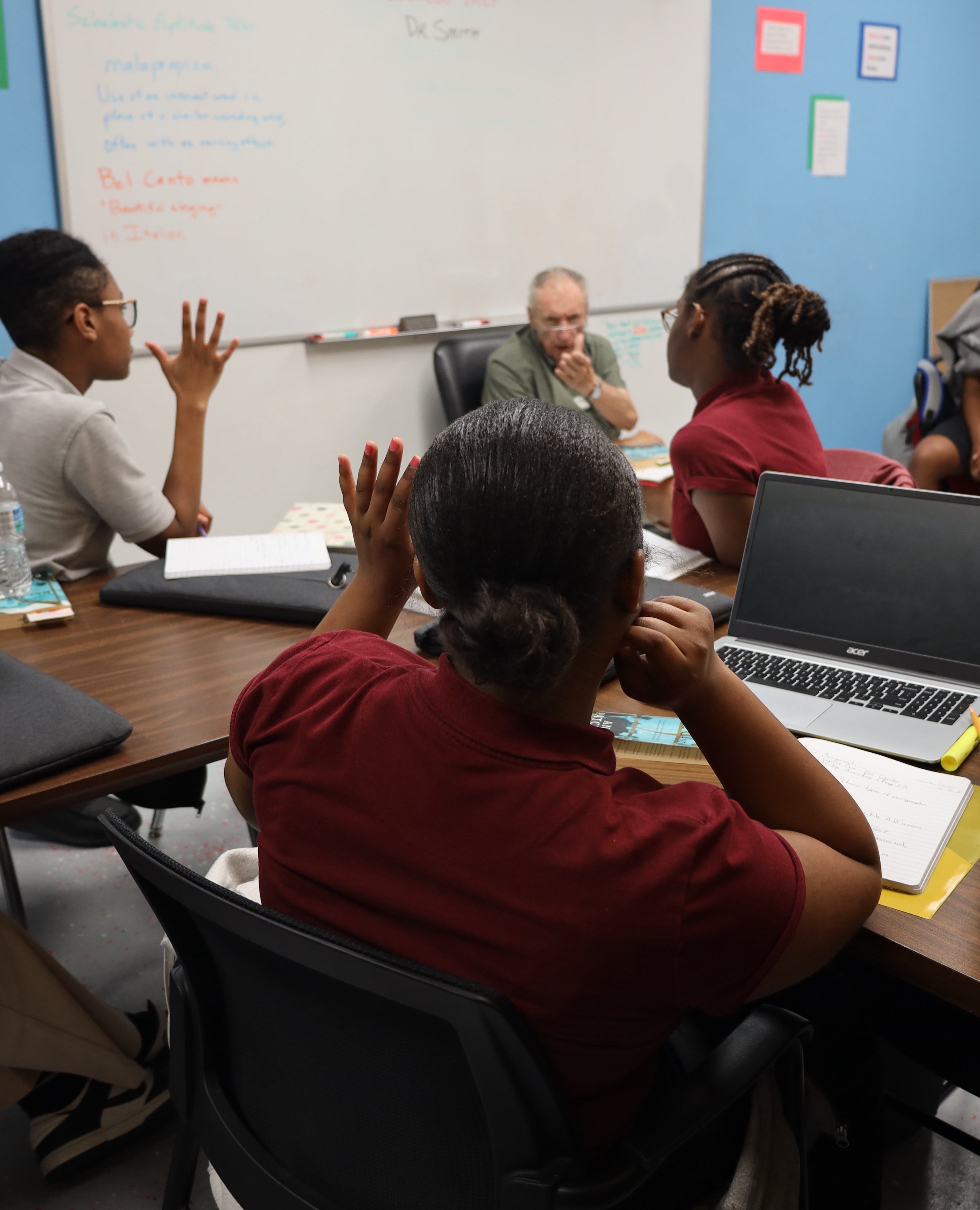 J.W. Reed Christian Academy students learning with their teacher