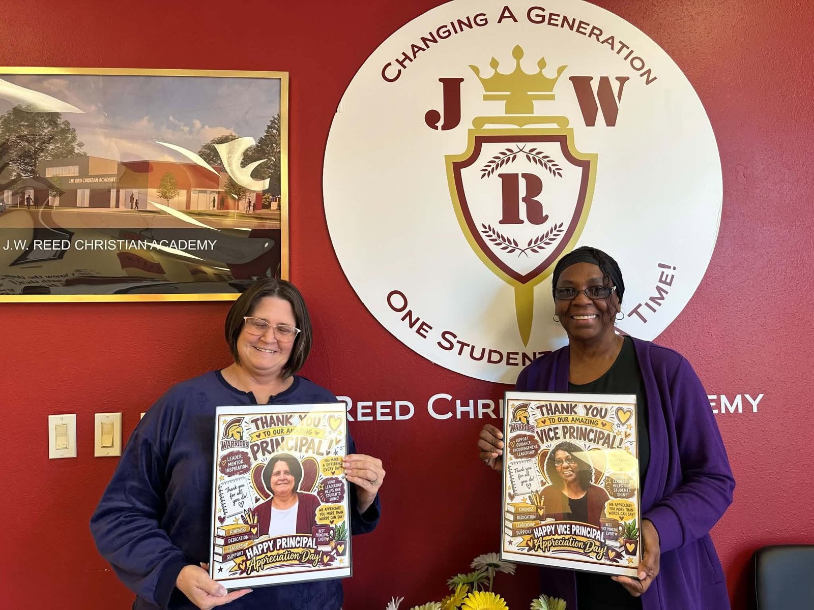 Administrators Tara and Stephanie holding framed appreciation keepsakes at J.W. Reed Christian Academy