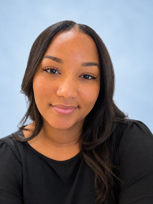 Bianca Henlon, JWRCA mental health counselor, against a soft blue background