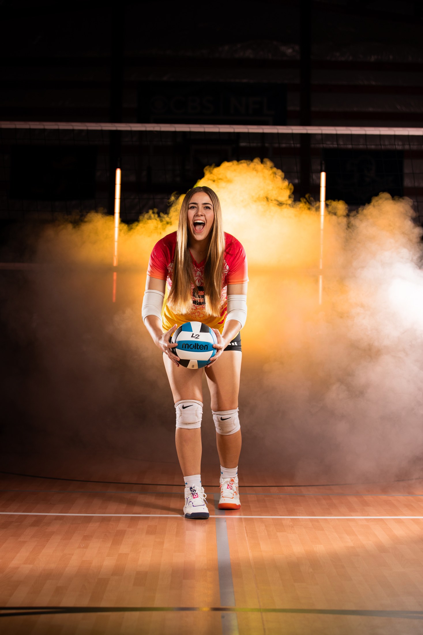 Young volleyball athlete holding a volleyball before practice