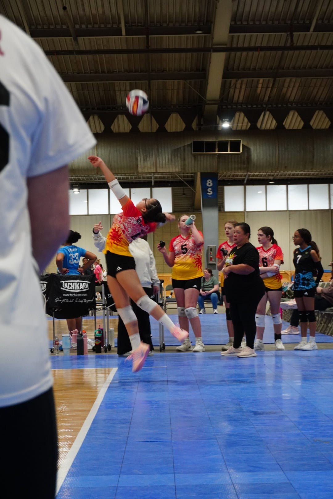 Club IMUA Volleyball athlete attacking the ball during a match