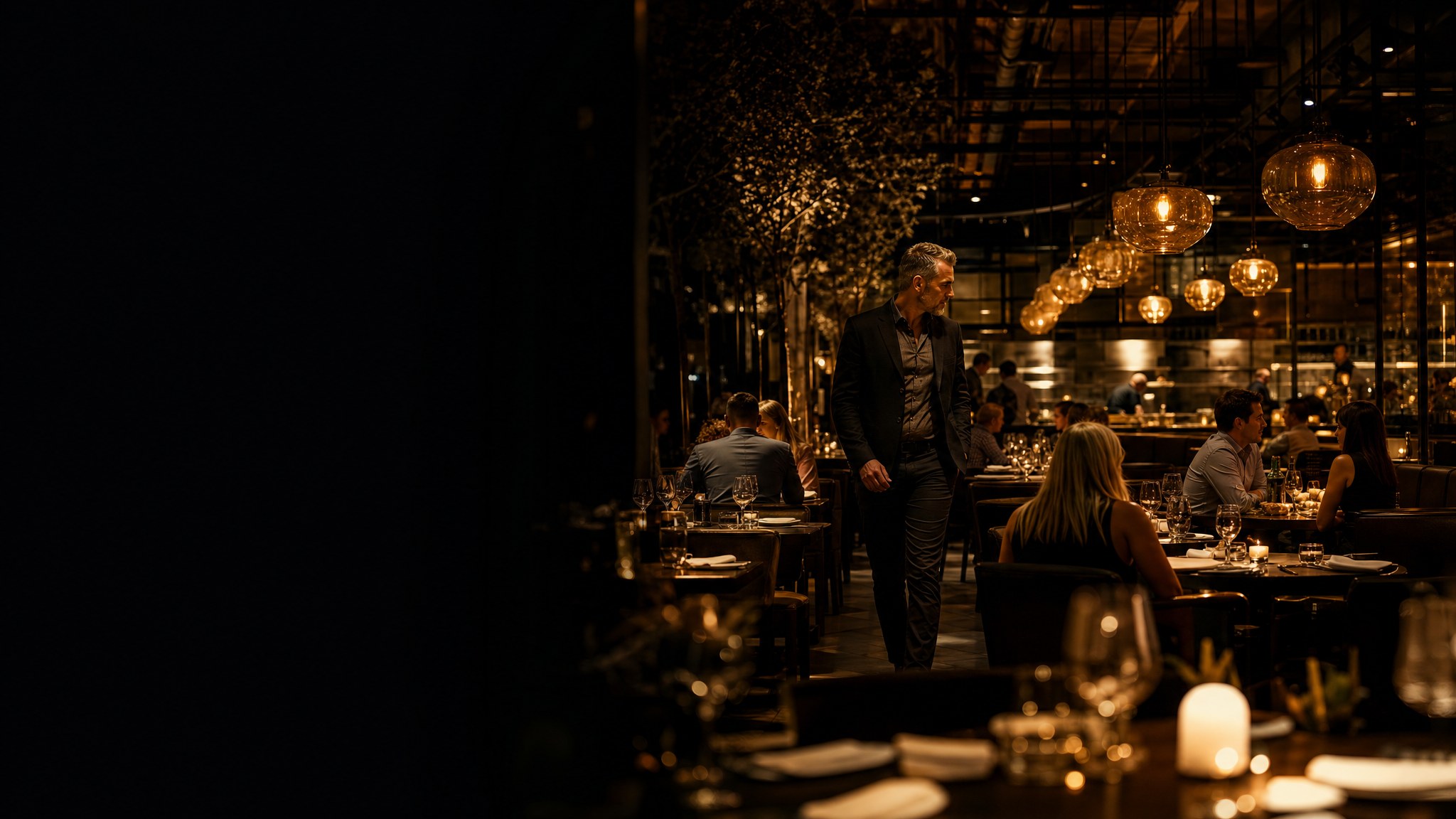 A warmly lit restaurant dining room during evening service