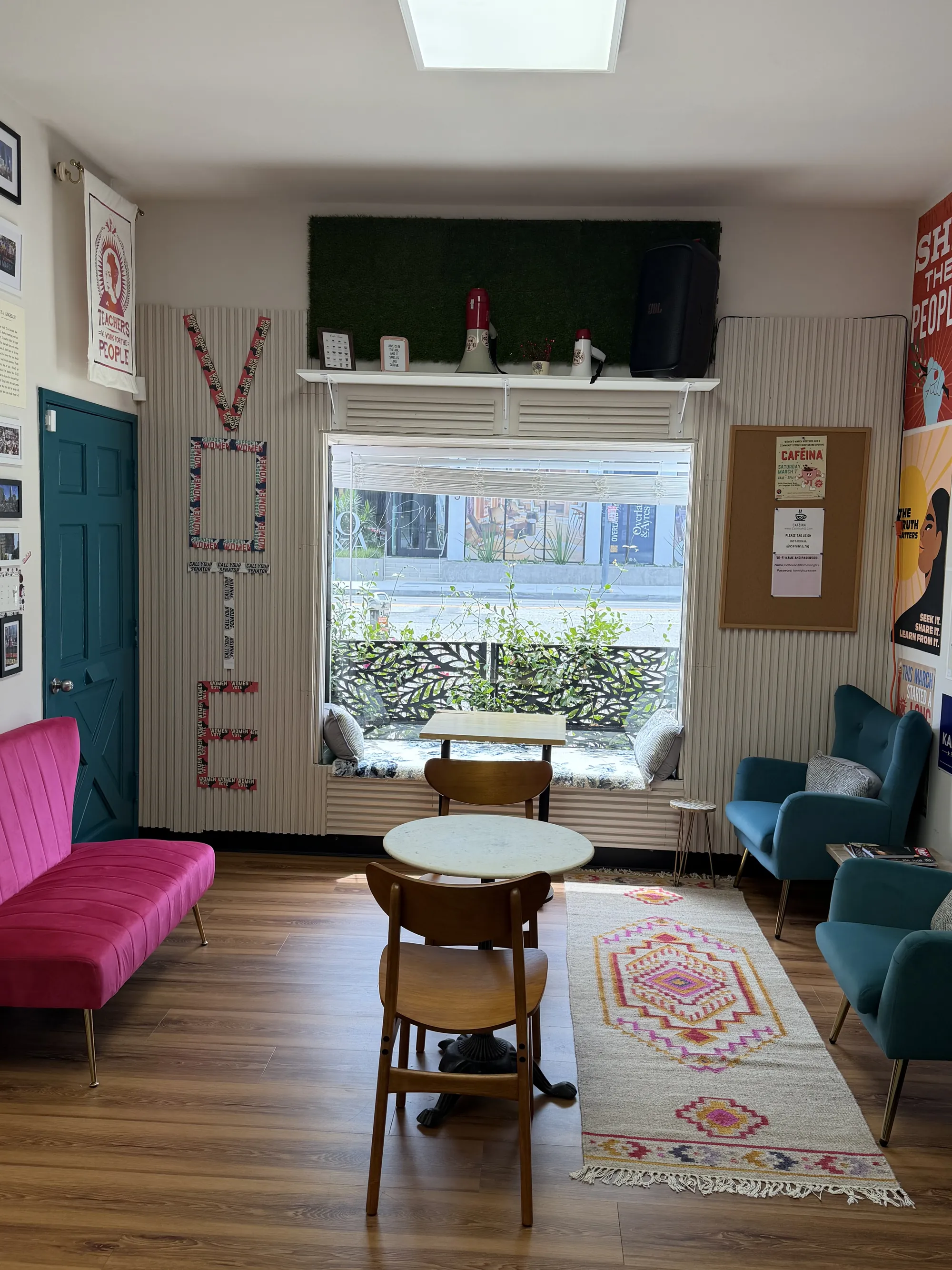 Lounge seating and artwork inside Caféina near Culver City