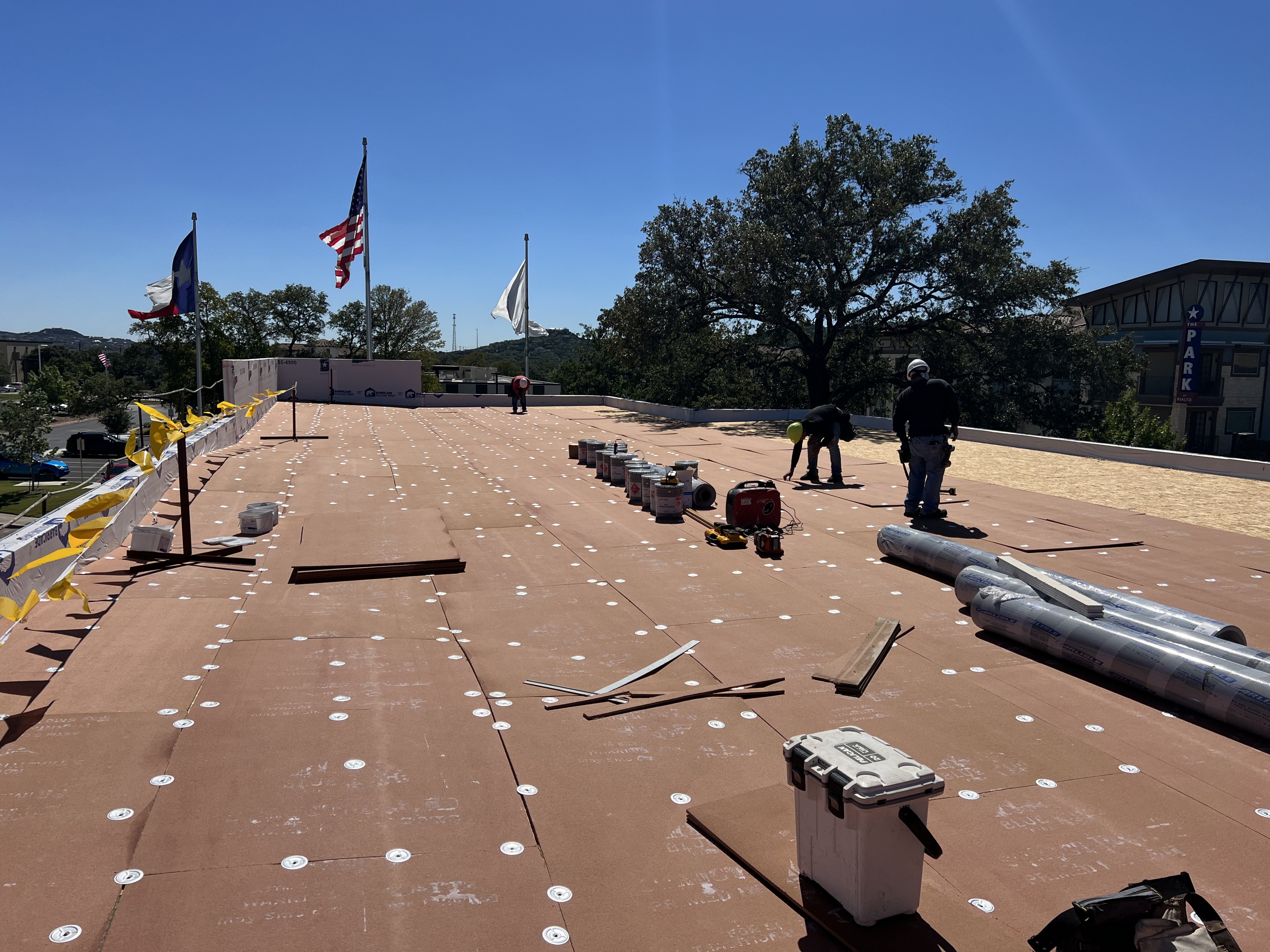 Commercial roofing materials and crew during installation