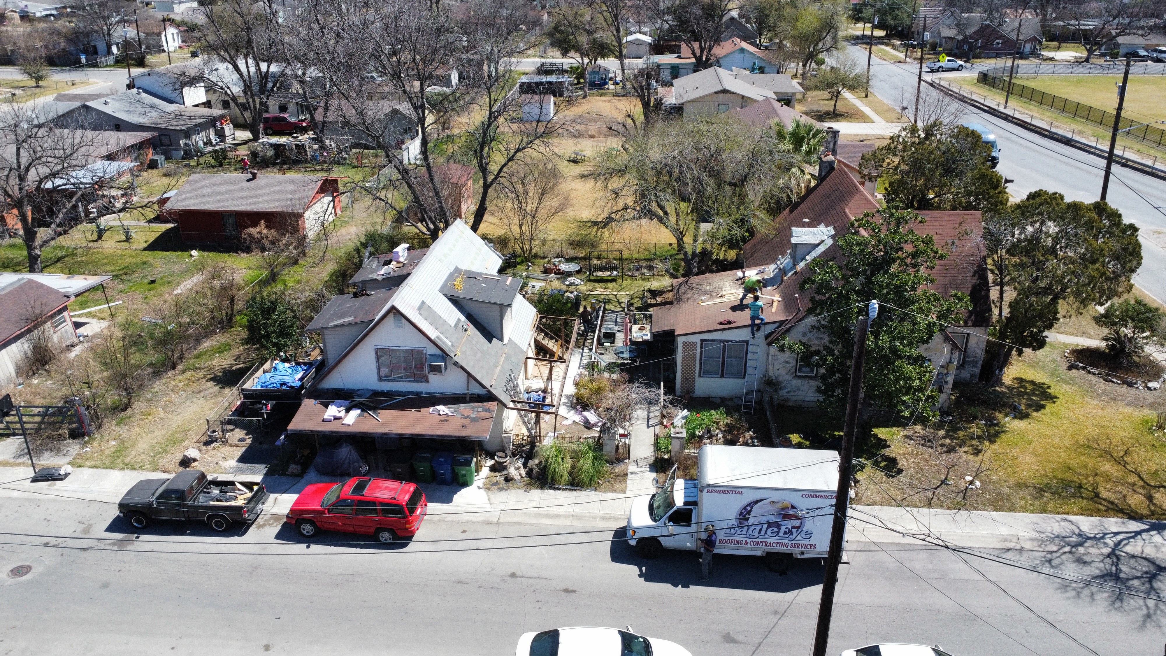 Aerial view of a storm-damaged home before restoration